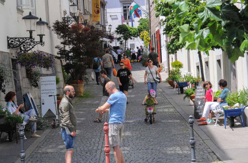 City street with numerous active people on it.