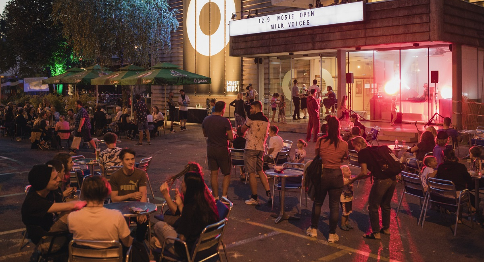 An evening event in front of an illuminated building.