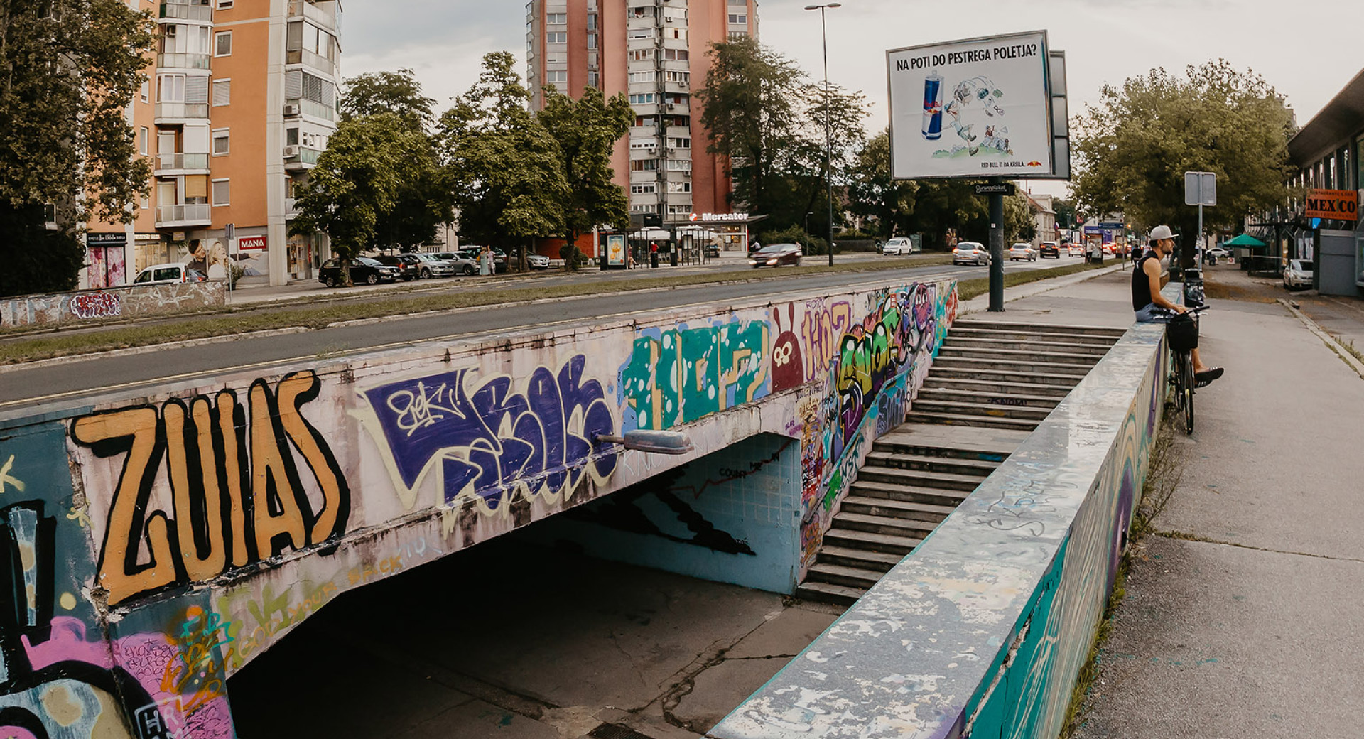 Graffiti-covered underpass in an urban setting.