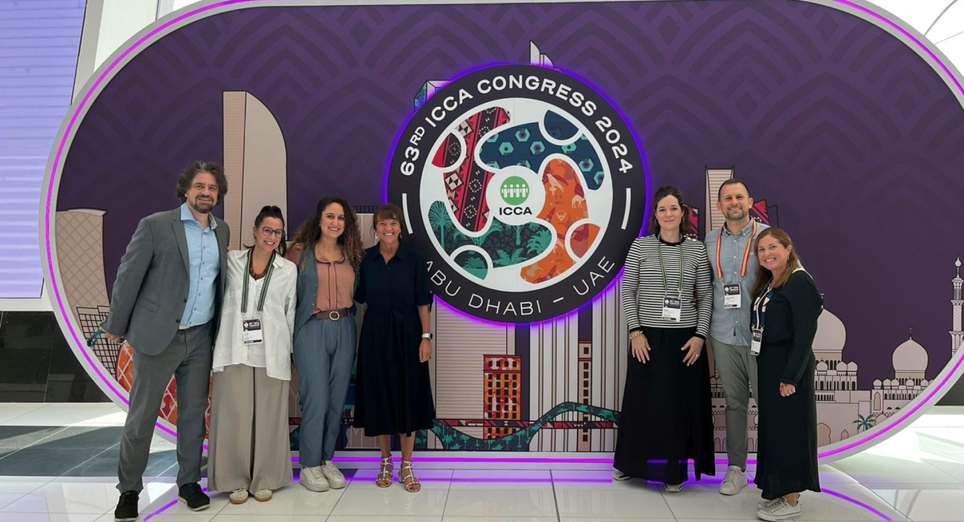 people standing in front of ICCA congress sign