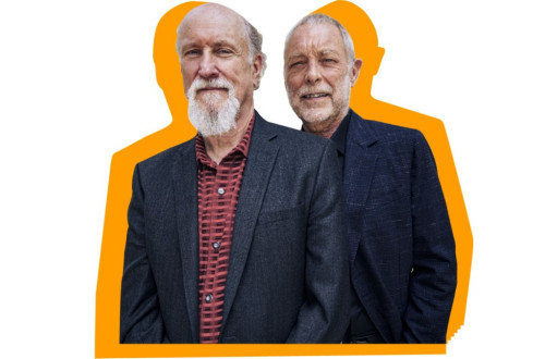 Two older men in jackets.