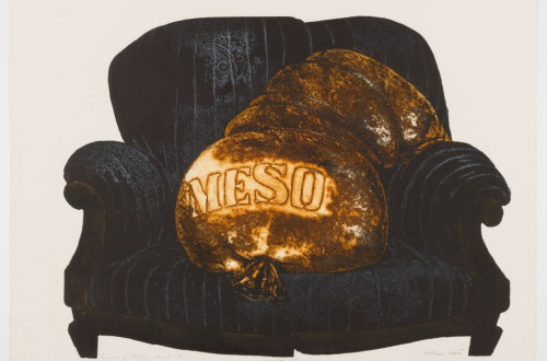 Dark blue armchair with yellow bag and the word meat written on it.
