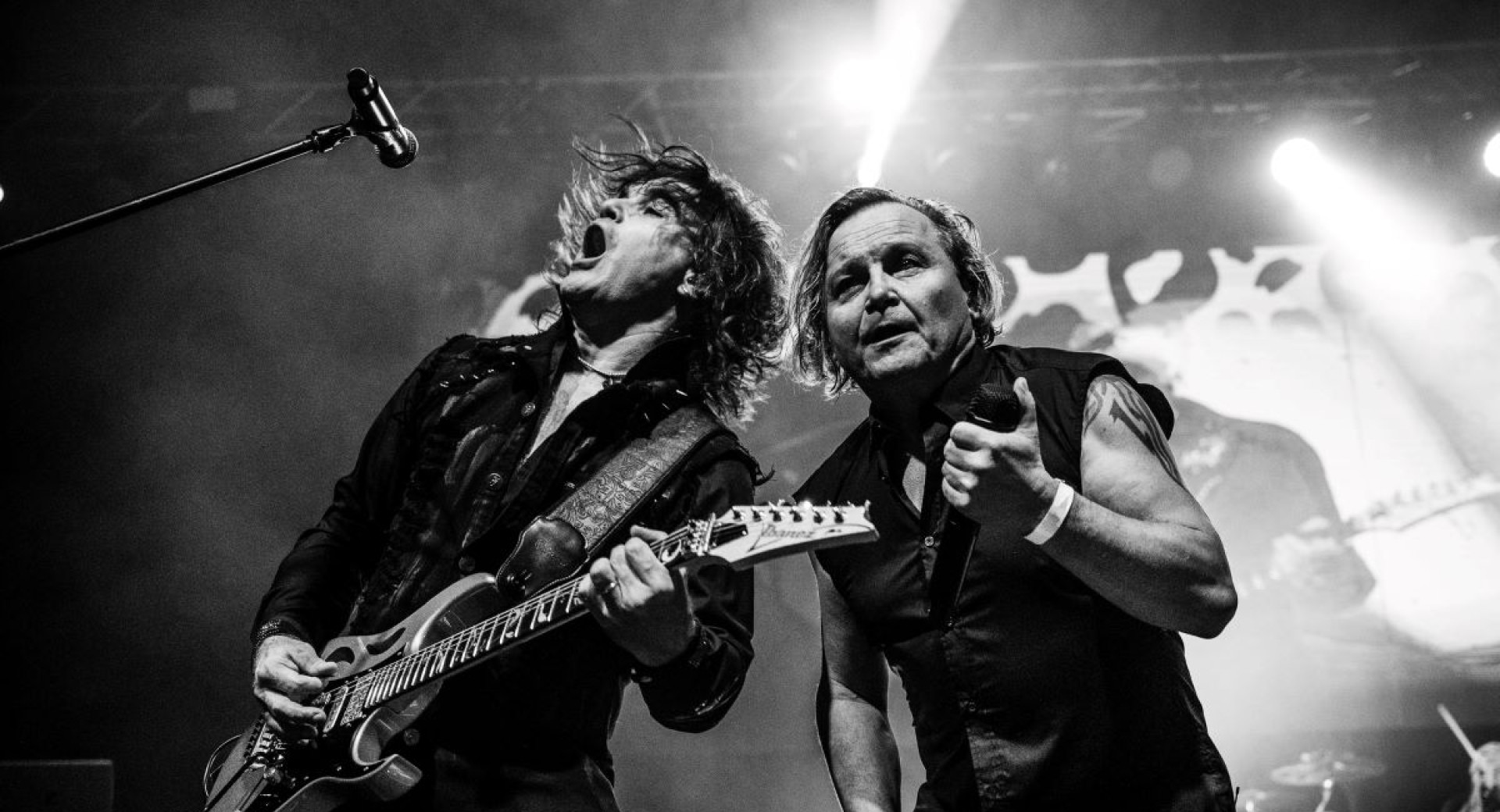 Black and white photo of two musicians with guitars.