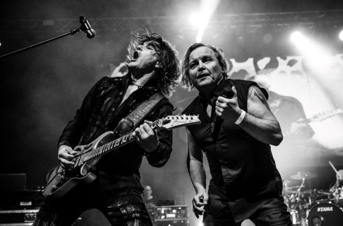 Black and white photo of two musicians with guitars.