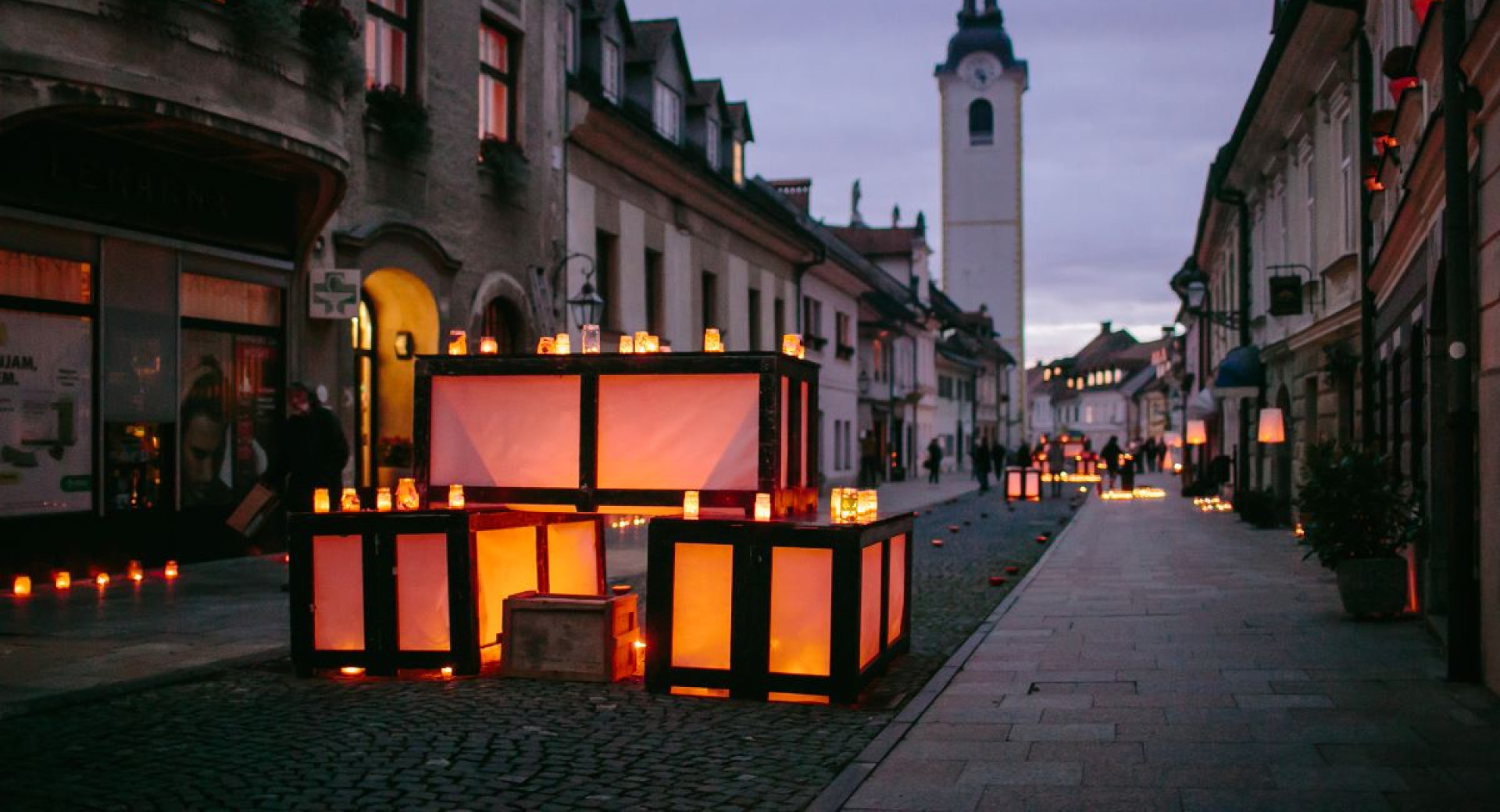 The festive lights are scattered along the city street.