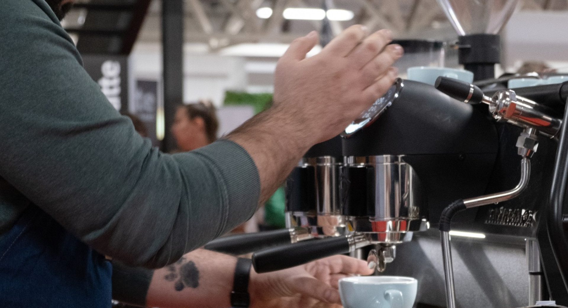 A man is pouring coffee into a cup.