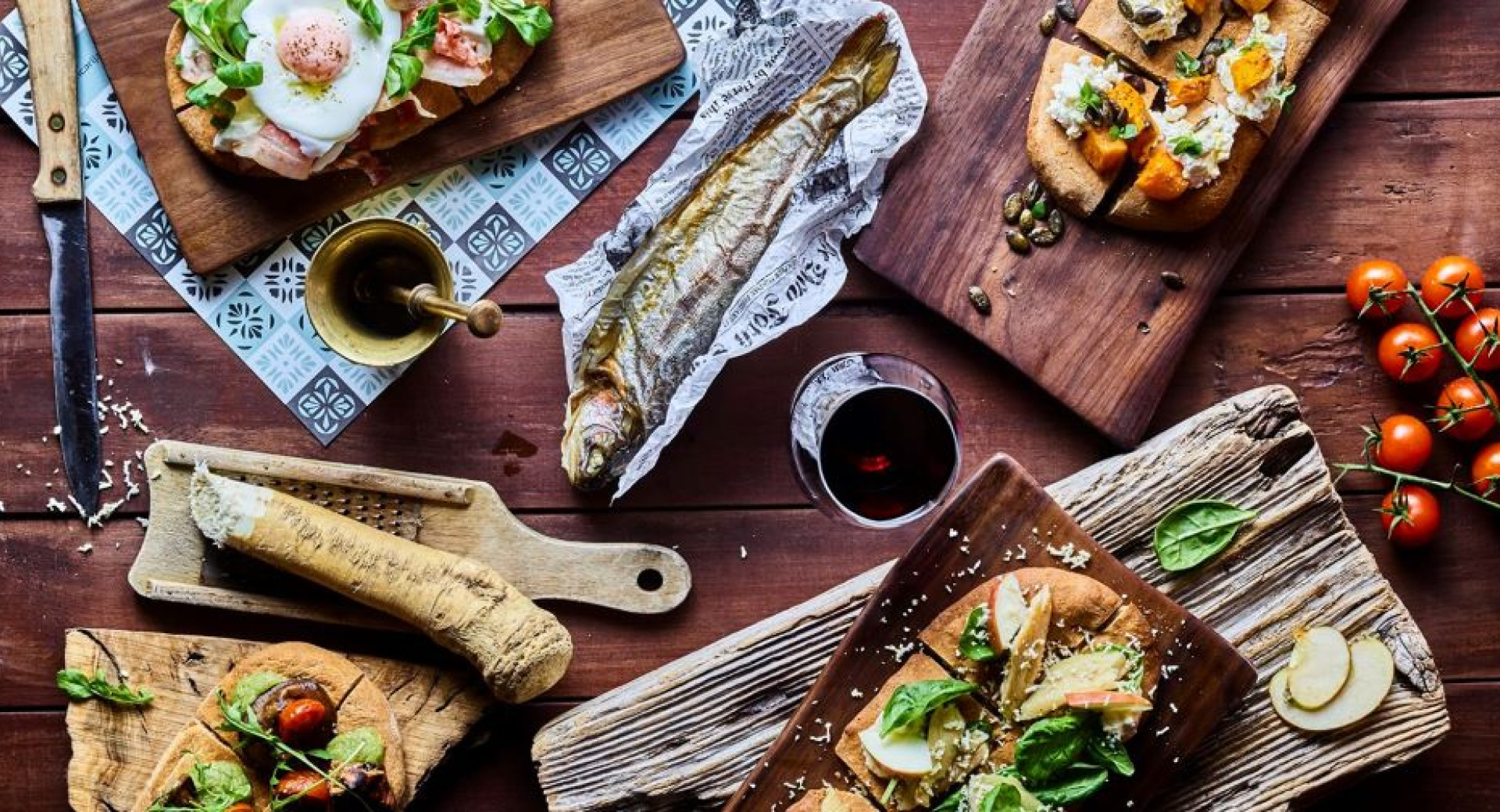 An assorted charcuterie platter is on the table, with various dishes set out for enjoyment.