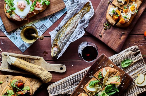 An assorted charcuterie platter is on the table, with various dishes set out for enjoyment.