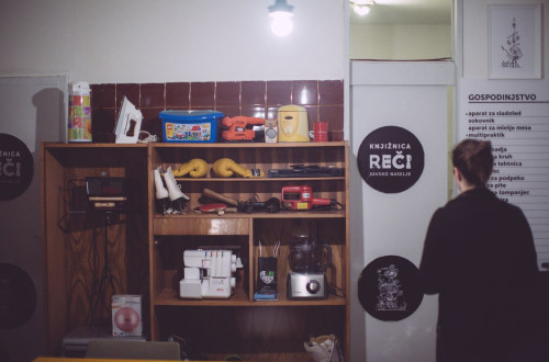 A community library of things with shelves filled with various household items, tools, and sports equipment.