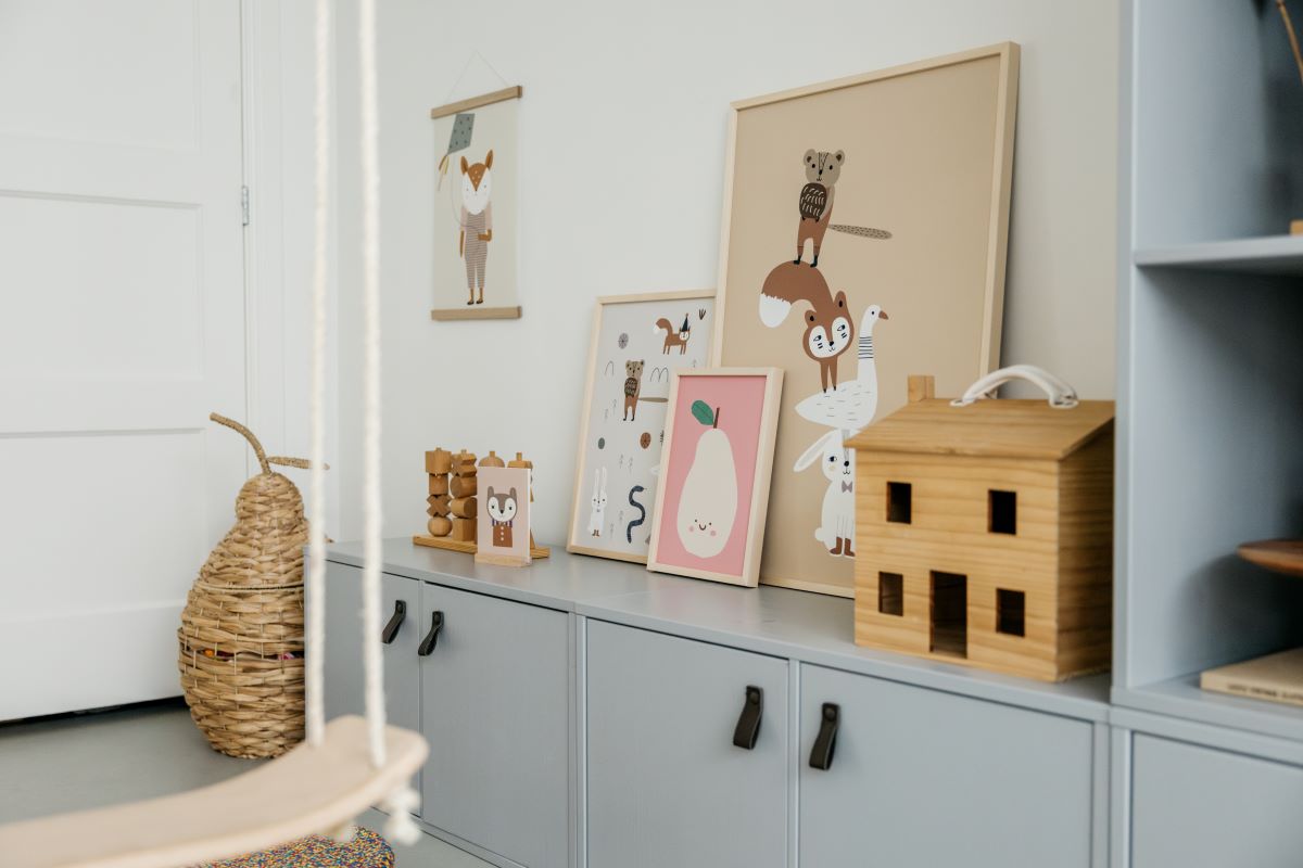 A children's room with cute animal illustrations on the walls, wooden toys, and colorful decorations.