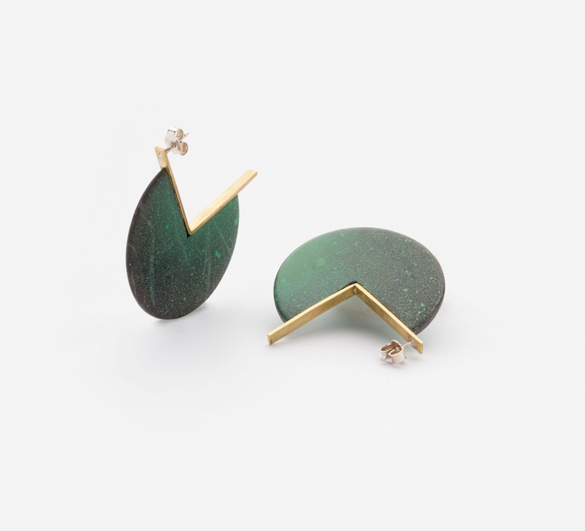 A pair of modern earrings with green circular elements and gold geometric details.