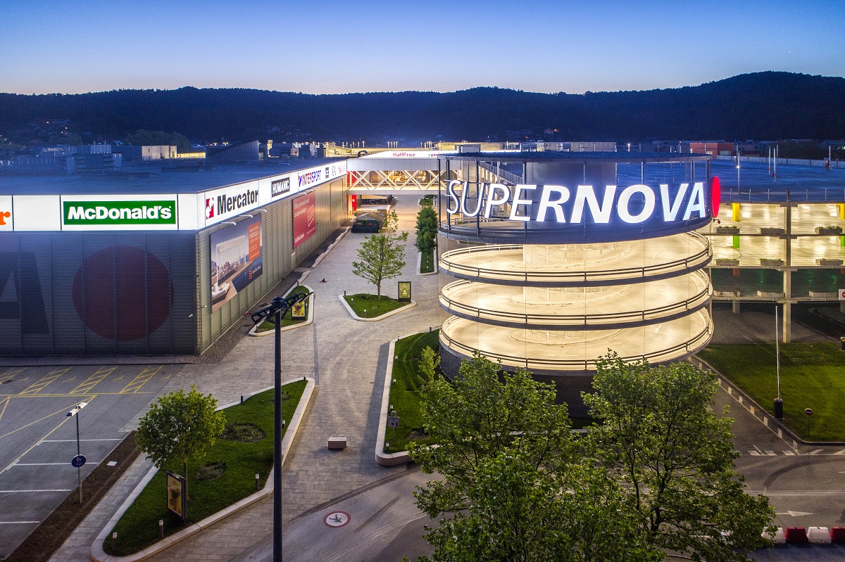 A distant view of an illuminated shopping complex on a large area.