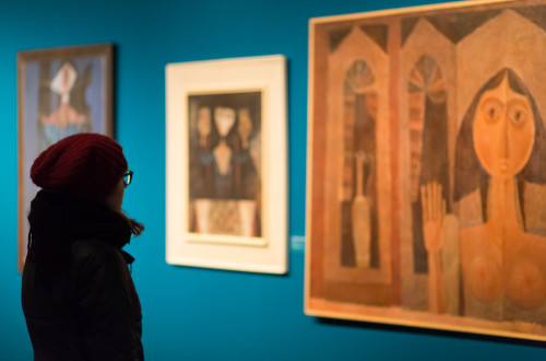 A visitor viewing the paintings.