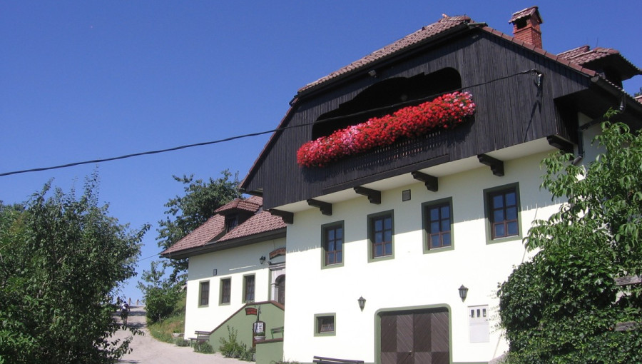 The exterior of an inn surrounded by trees.