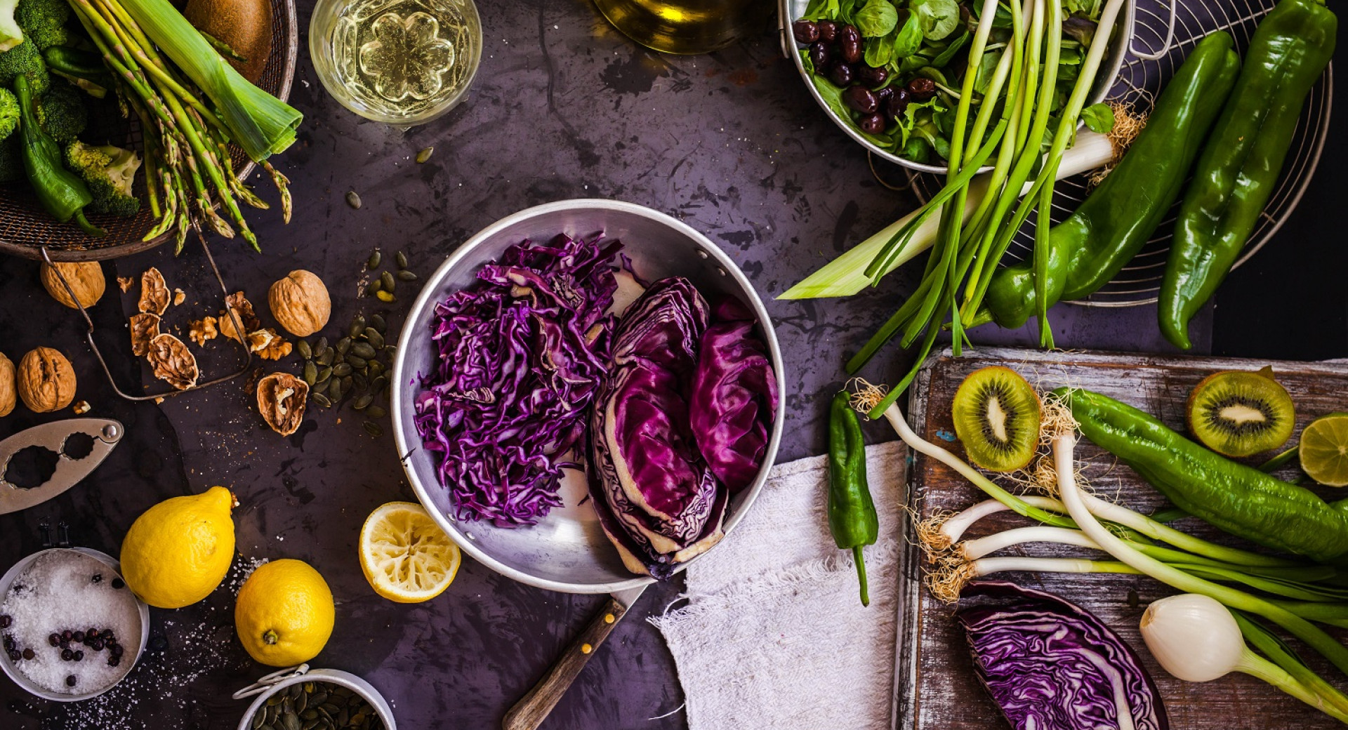 Dark grey table with various vegetable.