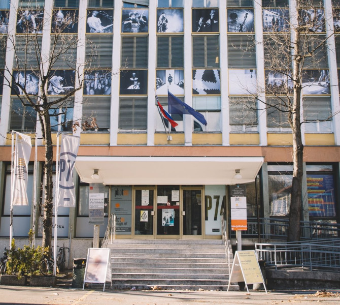 A large house with numerous windows and a flag.