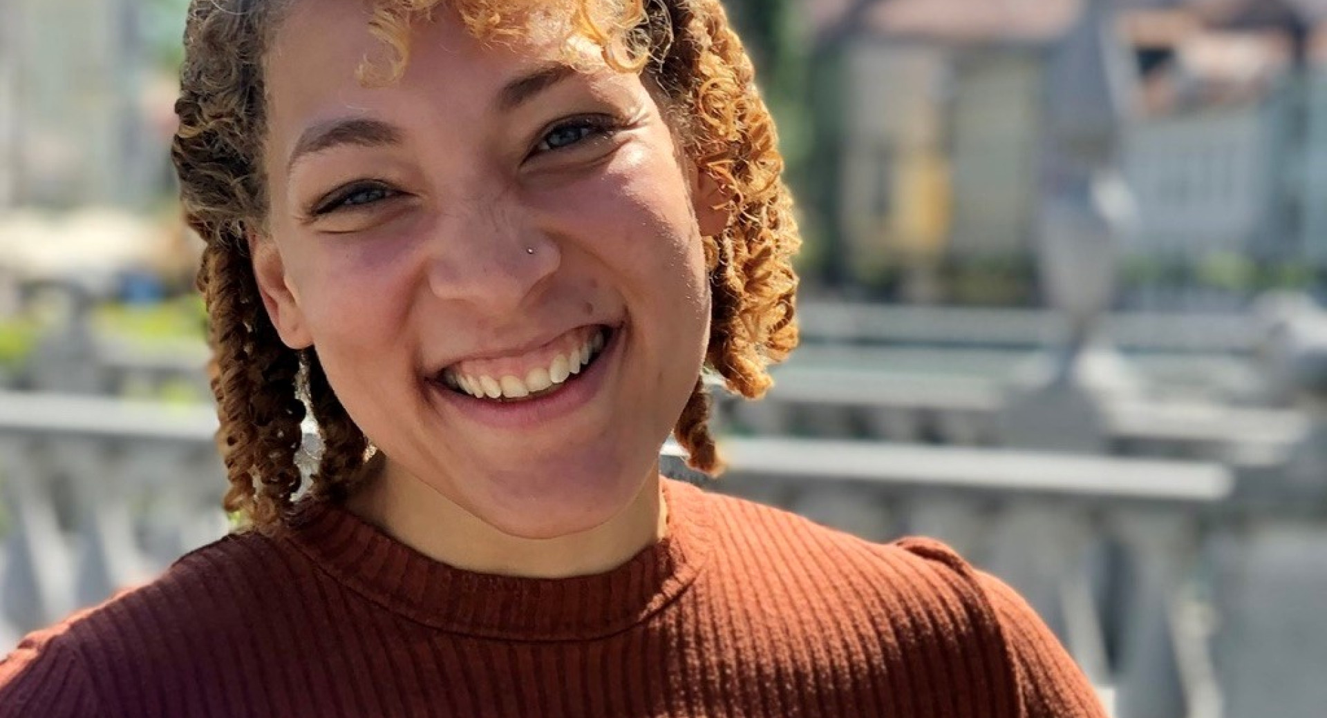 Smiling woman with curls.