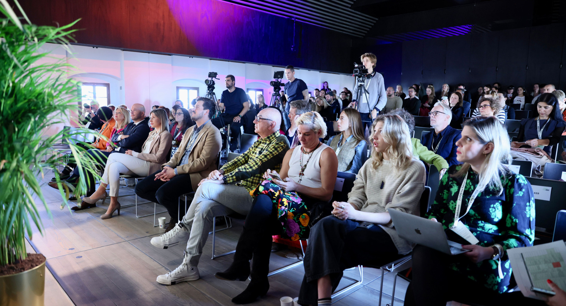 A group of people sitting in an auditorium.