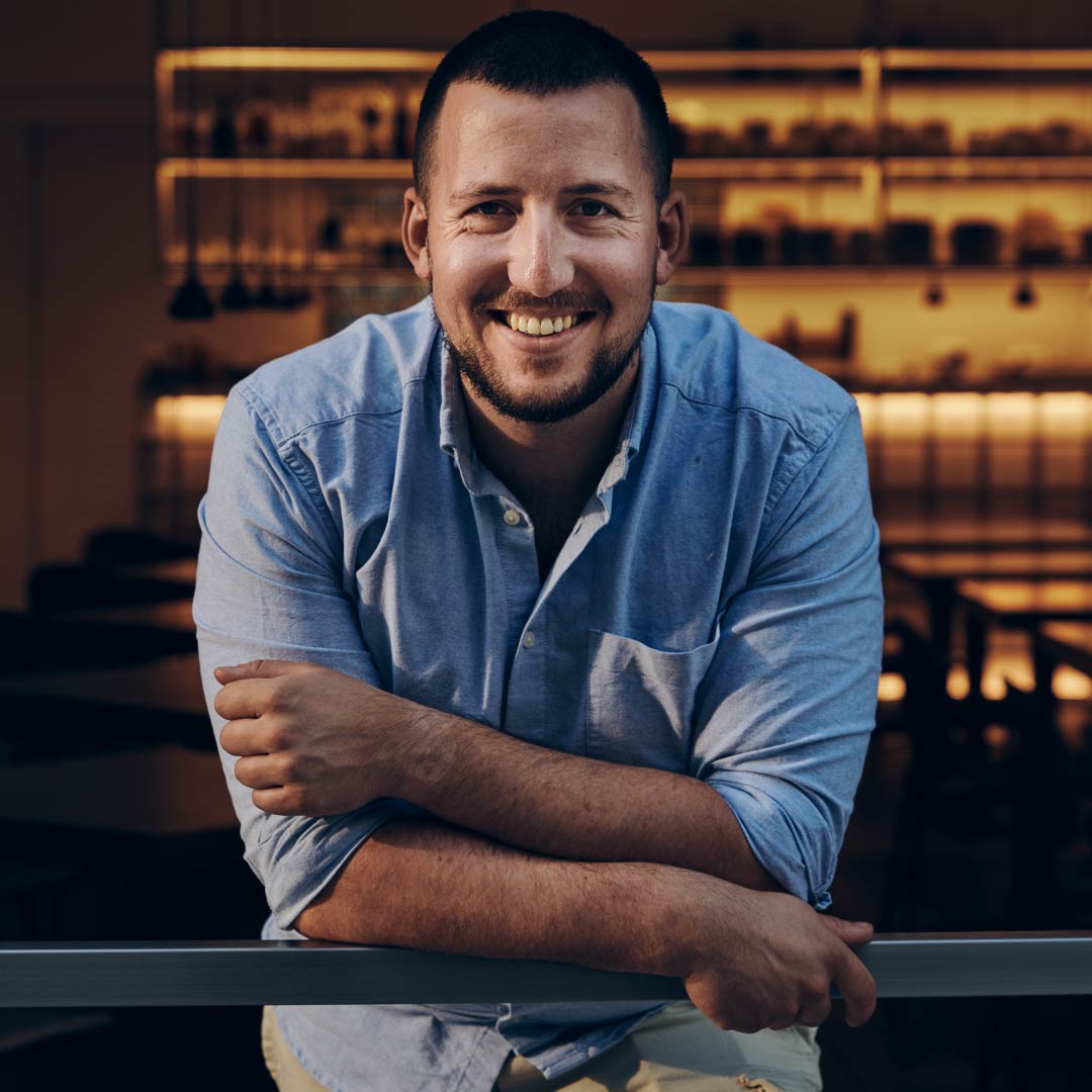 Smiling man in a blue shirt.