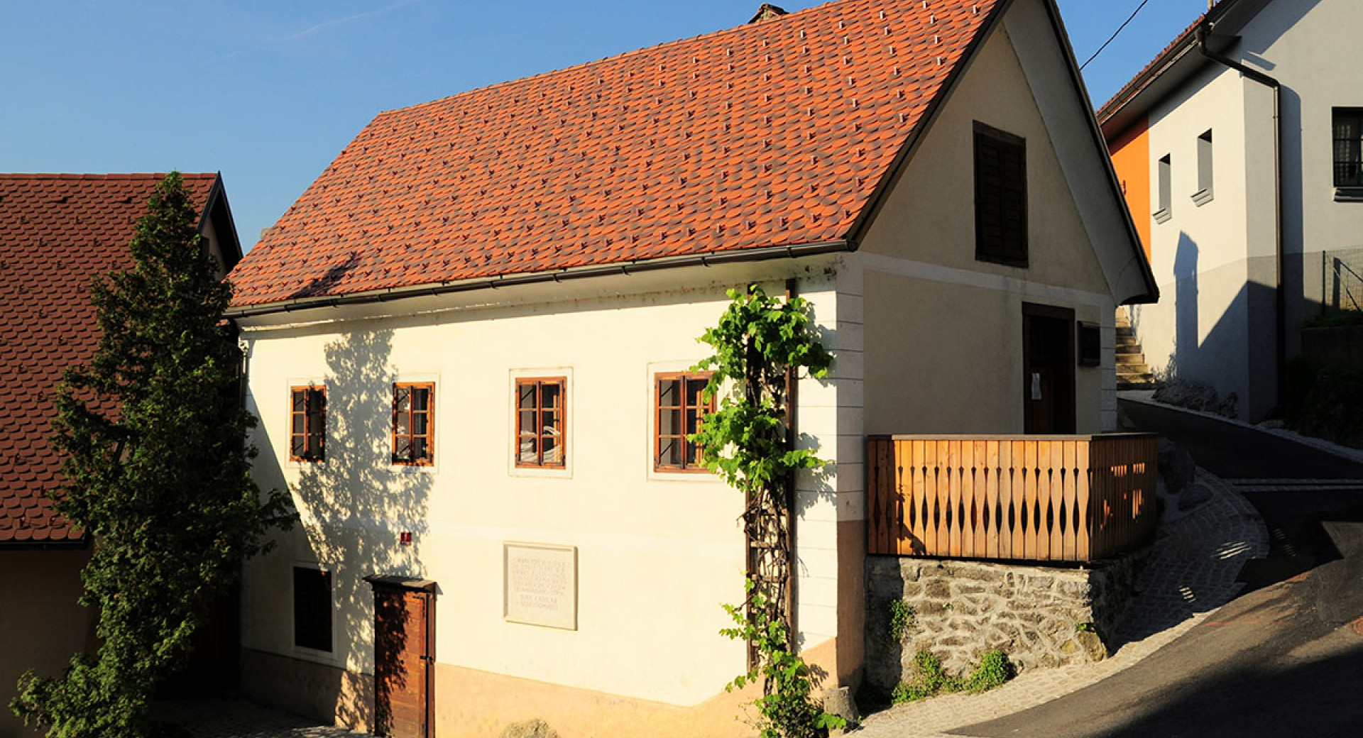 A two-story house with a wooden balcony.